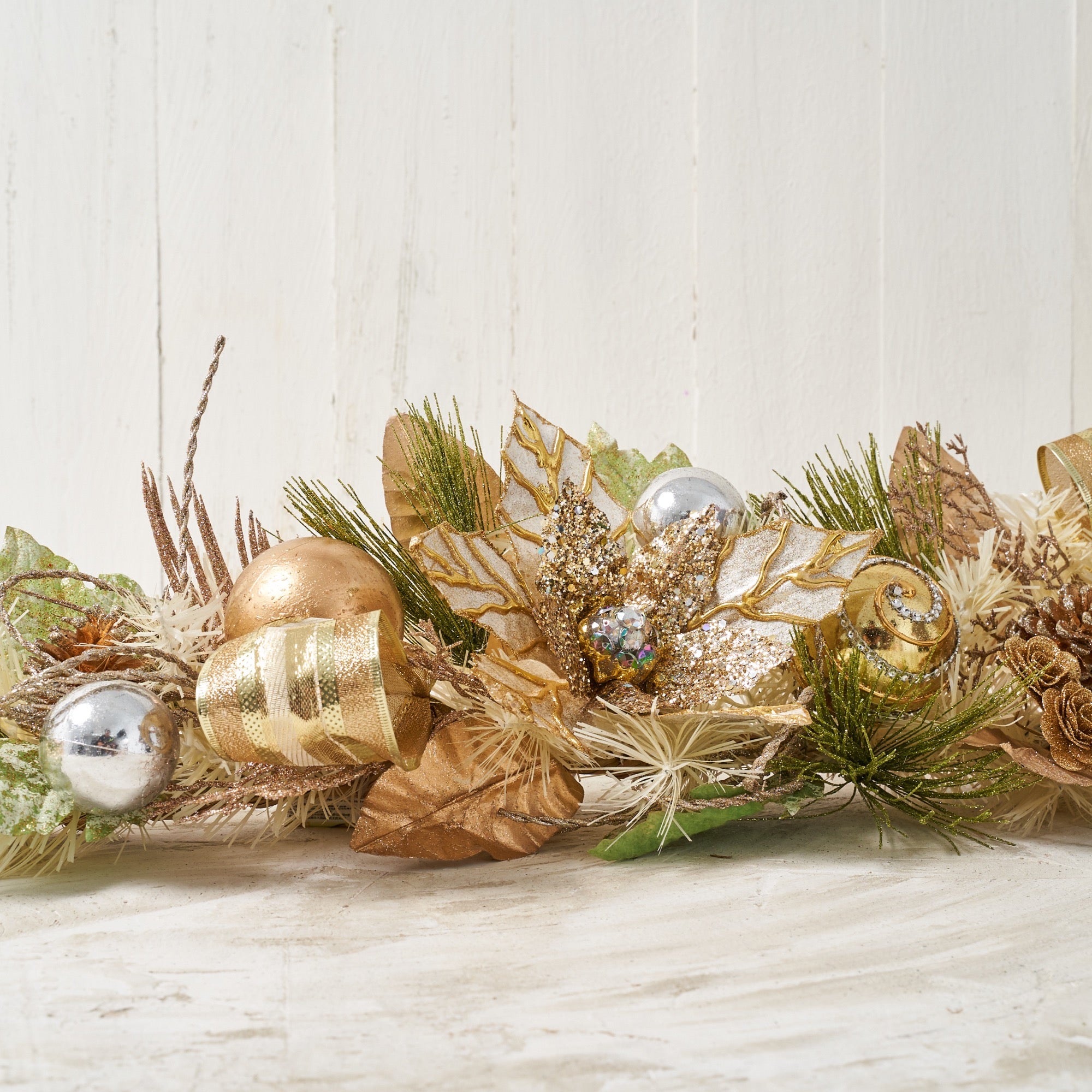 Handcrafted Champagne Gold Poinsettia Christmas Garland with glittery golden poinsettias, pinecones, mini roses, jeweled ornaments, and faux foliage.